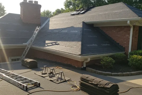 Professional roofer installing new shingles on residential home